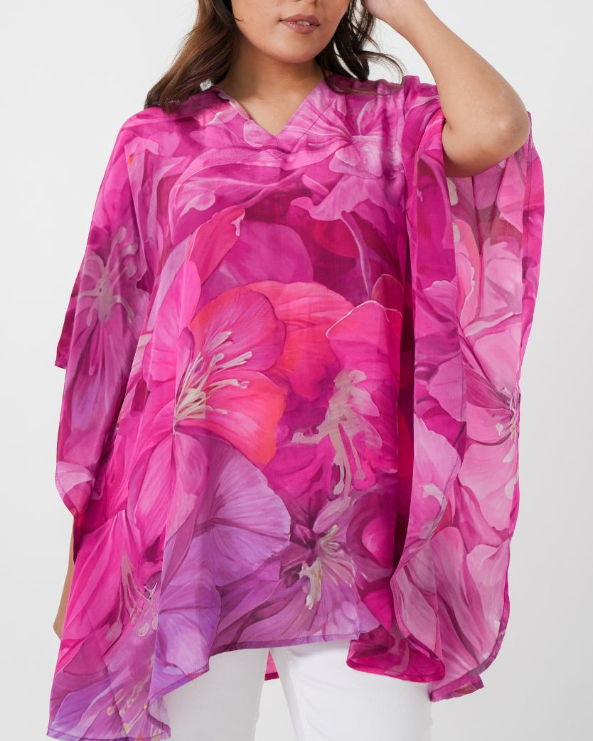 Woman wearing a pink floral kimono against a white background