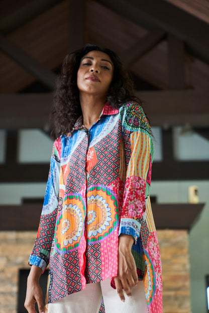 Side view of model wearing abstract print crepe shirt top with relaxed fit and flowy silhouette
