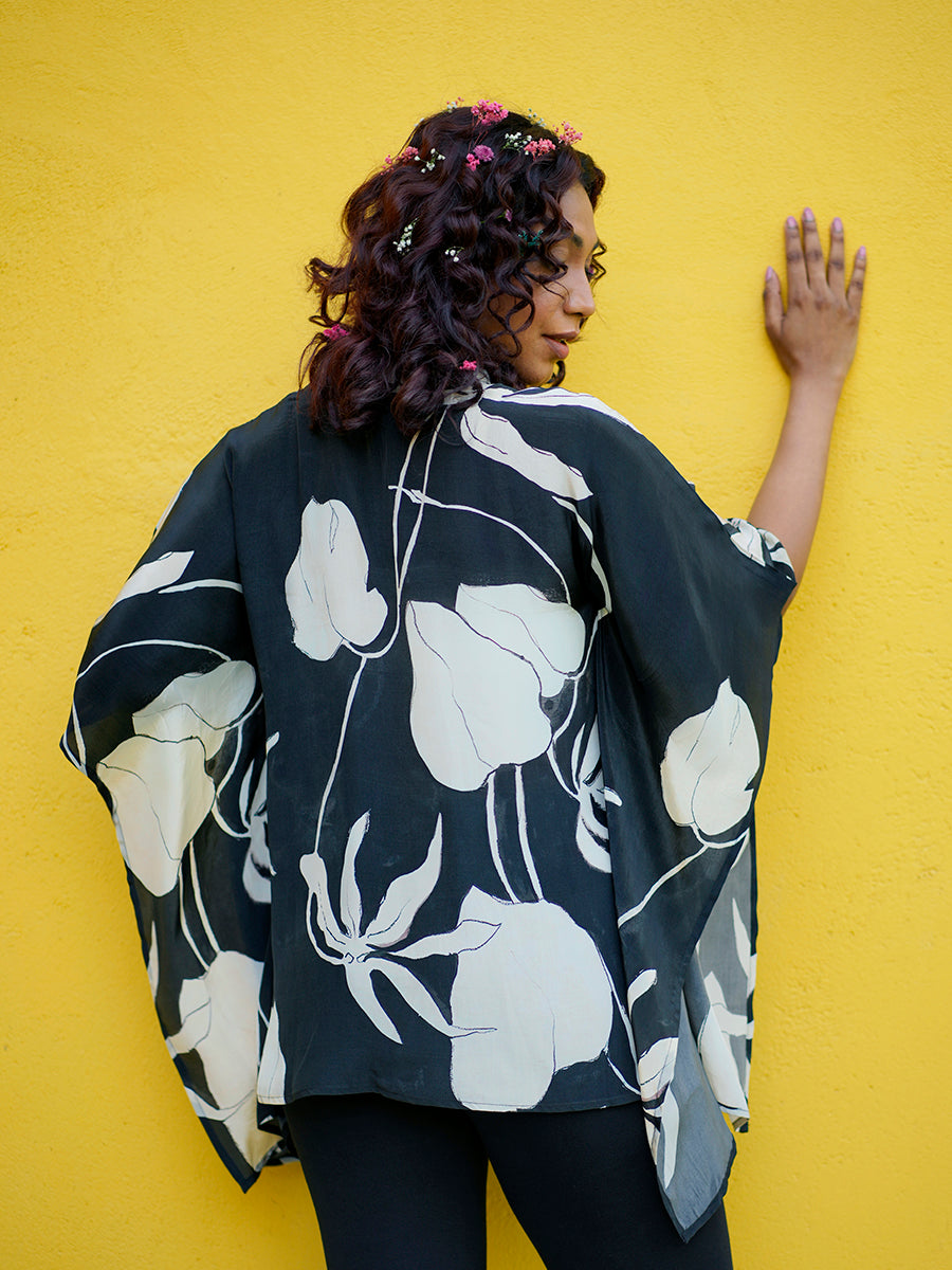 "Front view of Black Ivy Crepe Kaftan Top with bold black and white floral print and flowy relaxed silhouette."