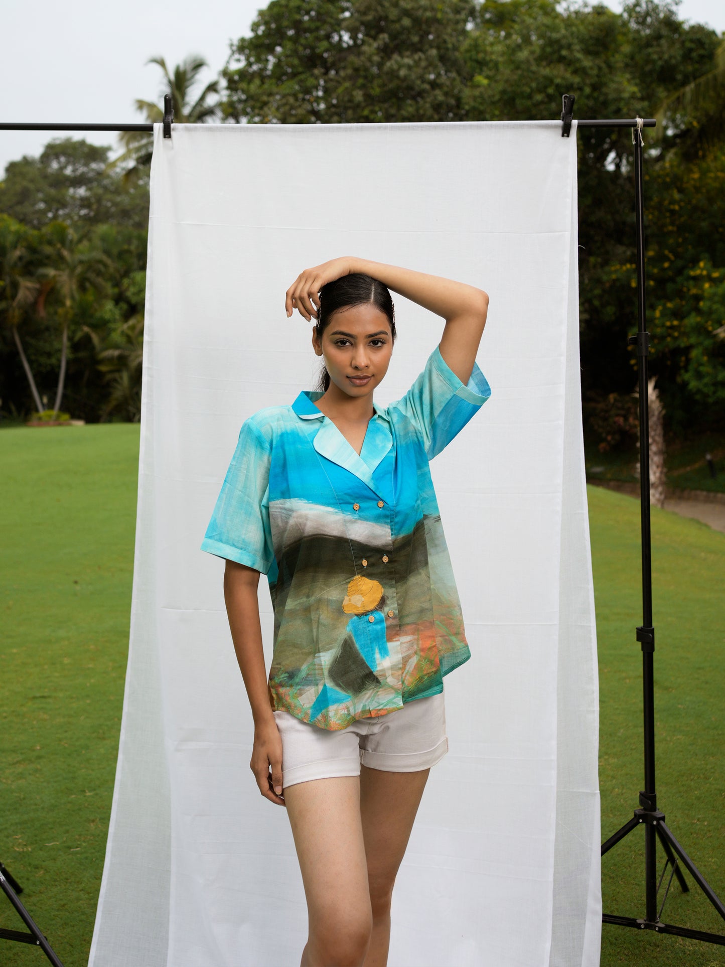 Front view of model wearing Philippino shirt top with bold tropical print and relaxed fit