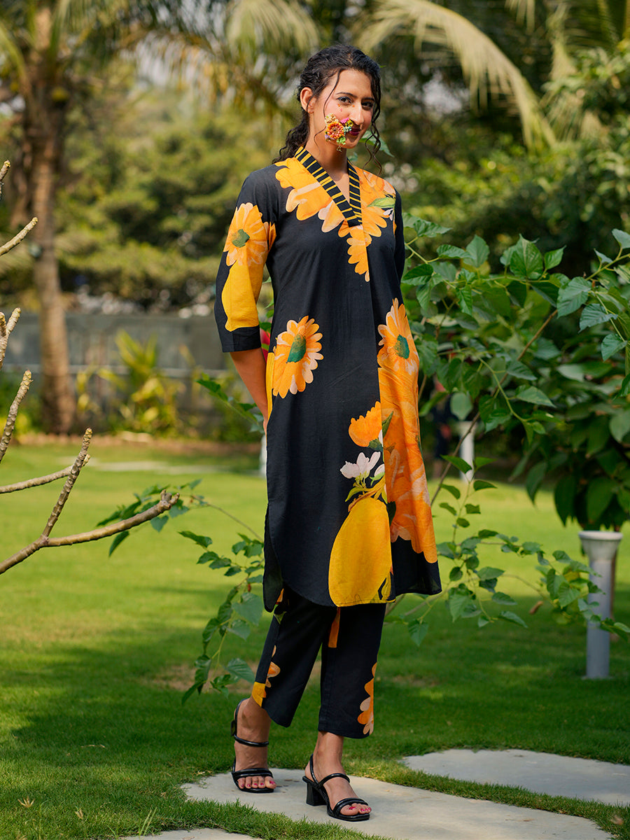 Flat lay of white cotton kurta and matching pants with bright sunflower print