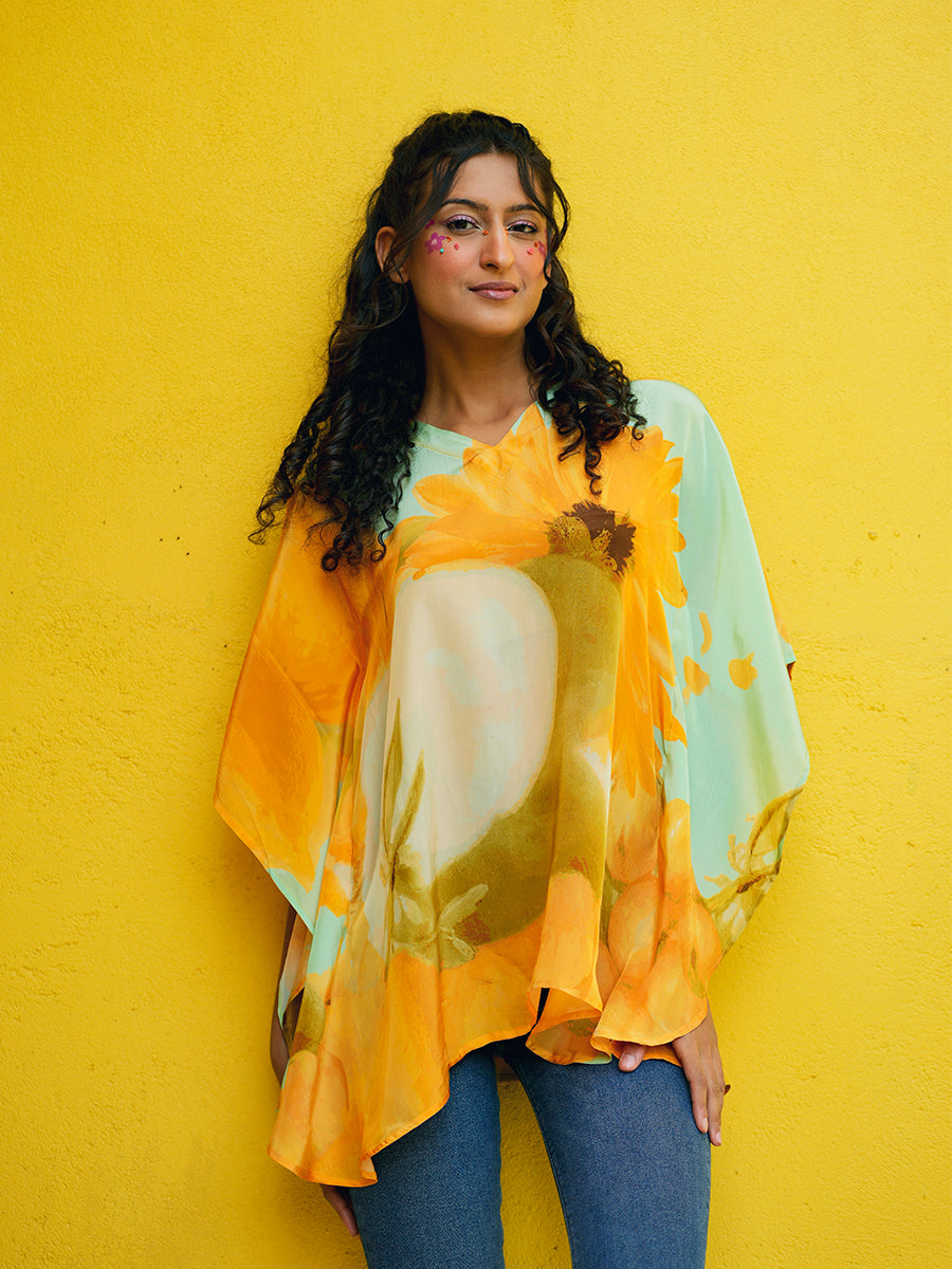 Full-length image of model pairing the kaftan top with white trousers, ideal for casual and vacation wear.