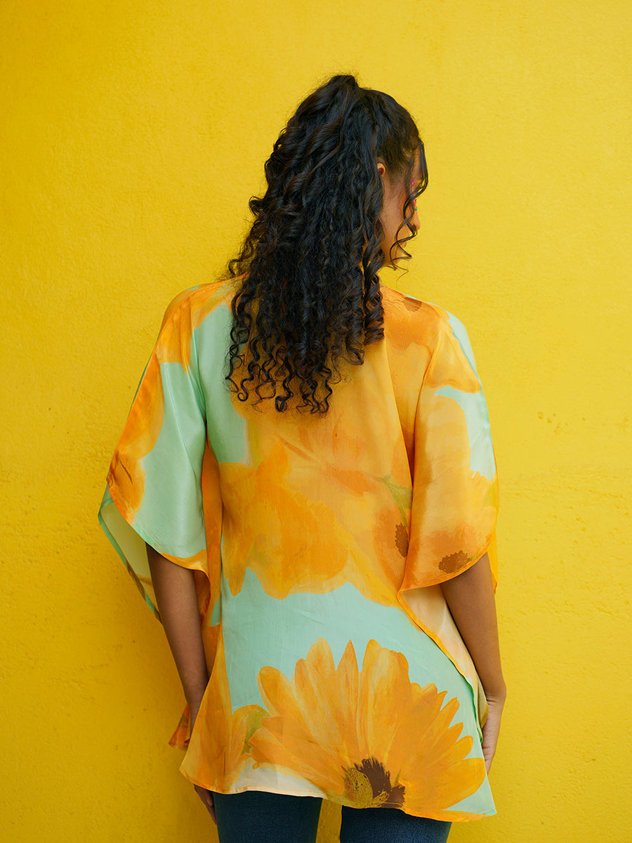 Close-up of the back side of the kaftan top showcasing the crepe texture and hand-drawn sunflower design.

